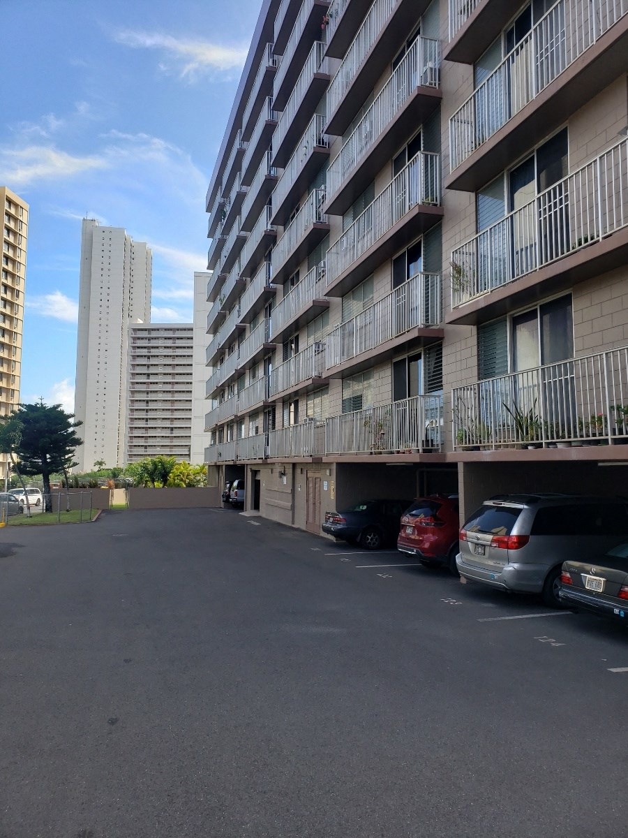 a parking lot in front of a tall building