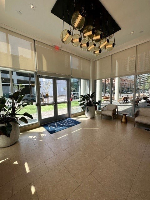 a large lobby with large windows and a large chandelier