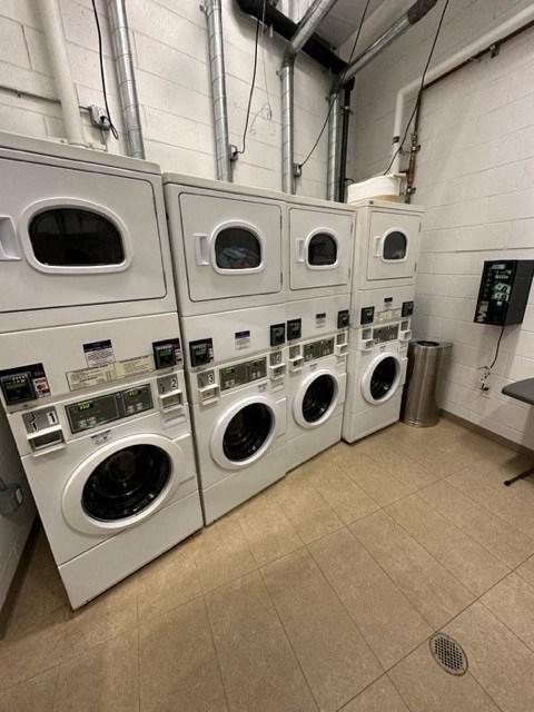 a row of washing machines in a laundry room