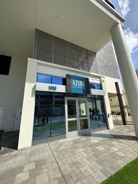 the front of an atrium building with glass doors