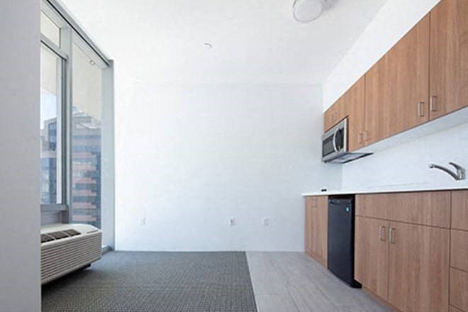 a living room with a microwave and a window