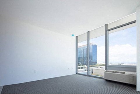 a living room with a large window and a radiator