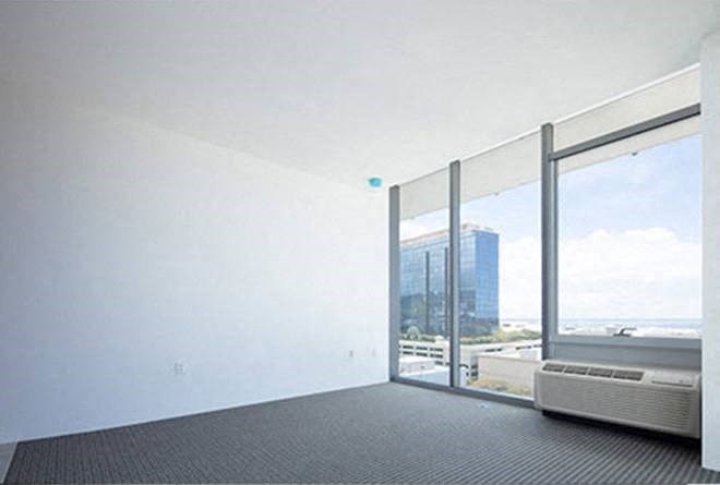 a living room with a large window and a radiator