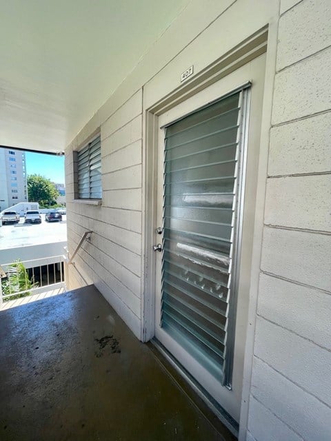 A white door with a window on the side of a building.