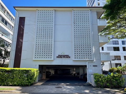 A white building with a large window and a garage door.