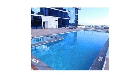 a large swimming pool next to a tall building