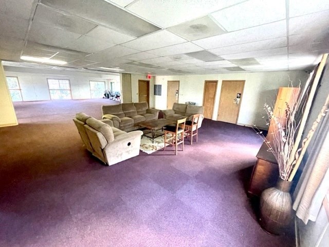 an empty room with couches chairs and a table