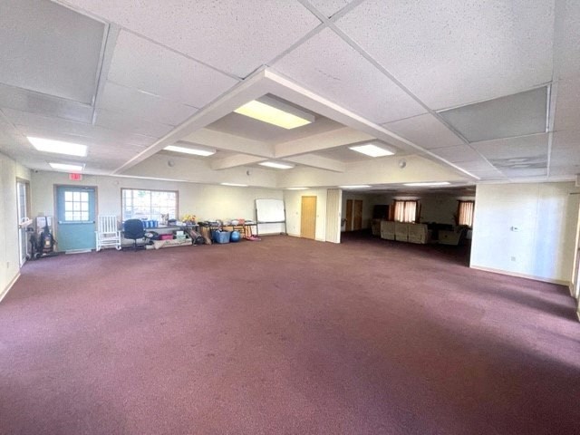 a large room with a pink carpet and white walls