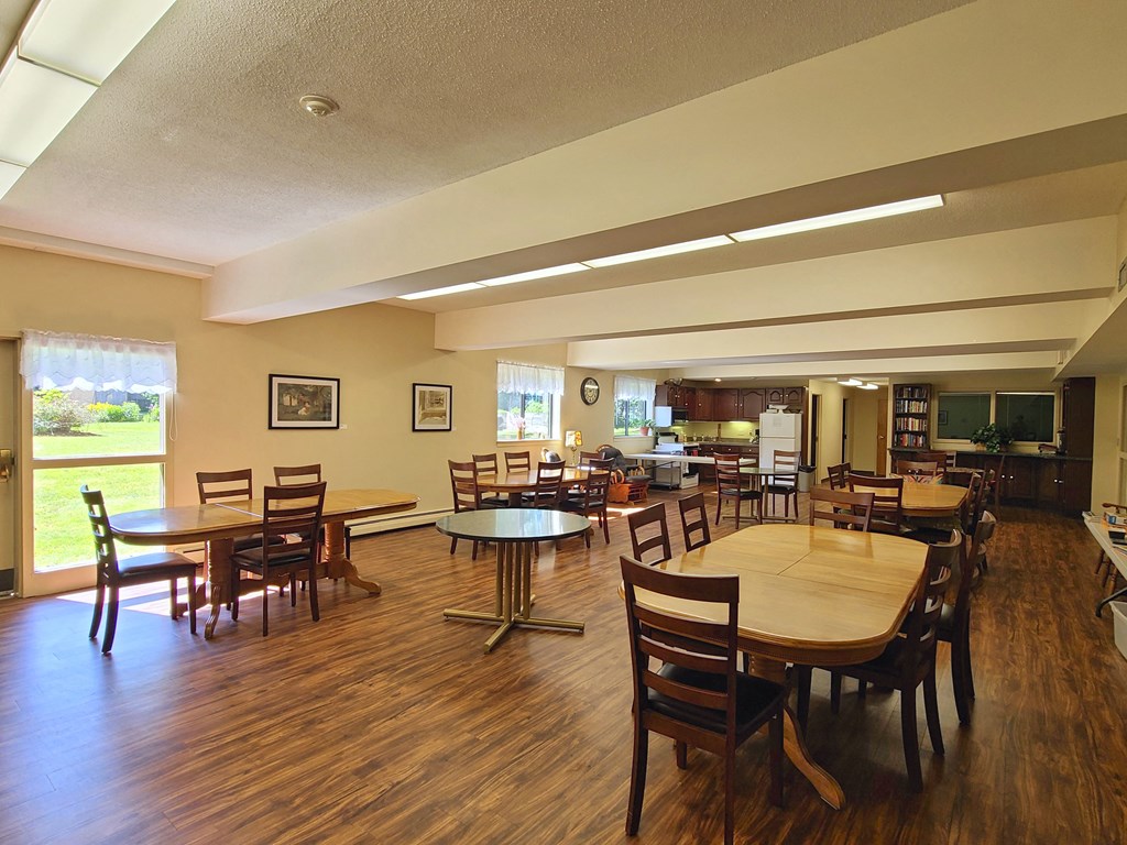 Country Park community room with tables for chatting and dining as well as adjascent full kitchen for community cooking.