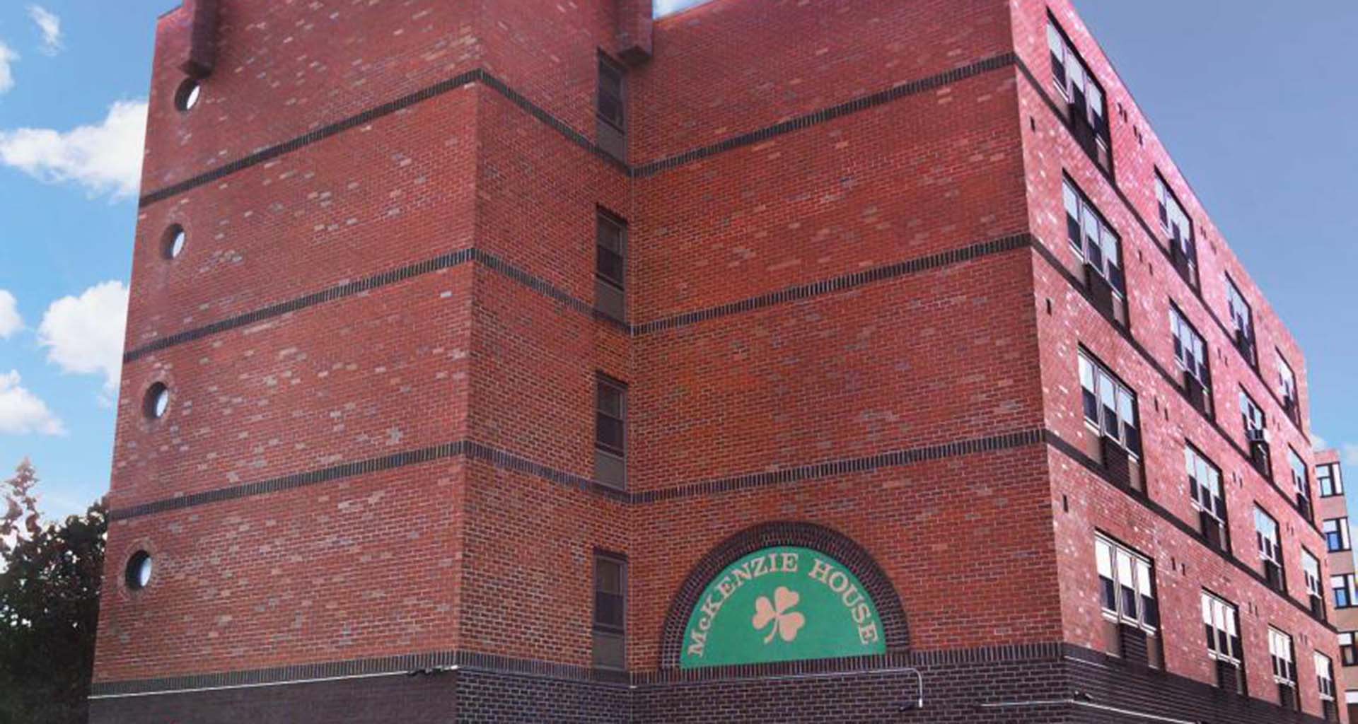 Exterior of multi-story brick McKenzie House apartment building