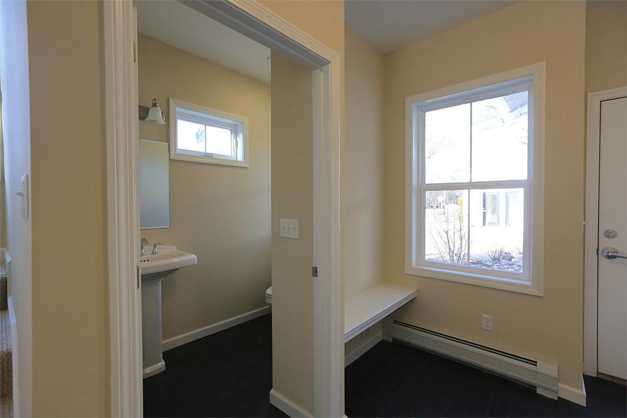Entryway to the aparment with first floor bathroom on the left