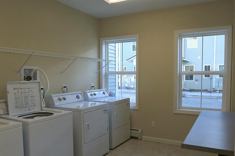 Rye laundryroom with two washers and dryers