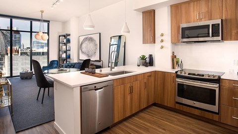 A modern kitchen with wooden cabinets and stainless steel appliances.