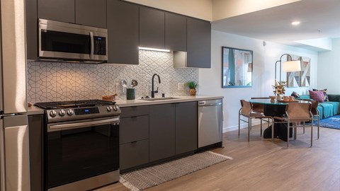a kitchen with a stove and a sink and a table