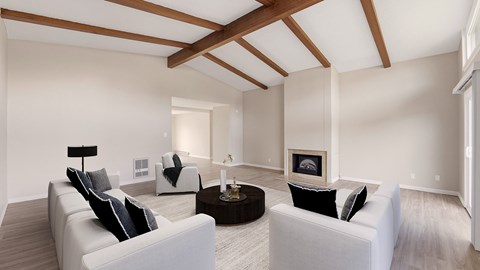 A living room with white furniture and a fireplace.