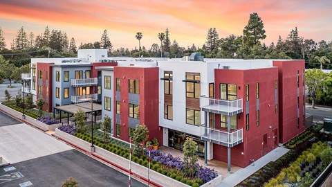 A modern apartment complex with red and blue buildings.
