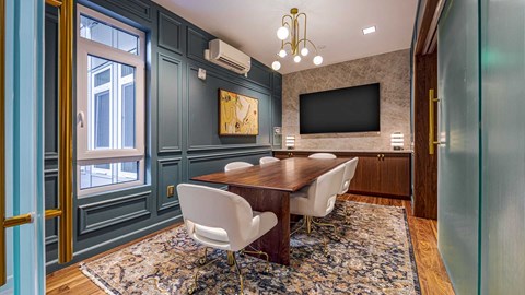 A dining room with a wooden table and chairs.