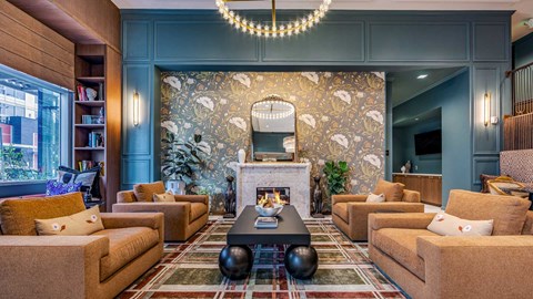 A living room with a fireplace and a chandelier.