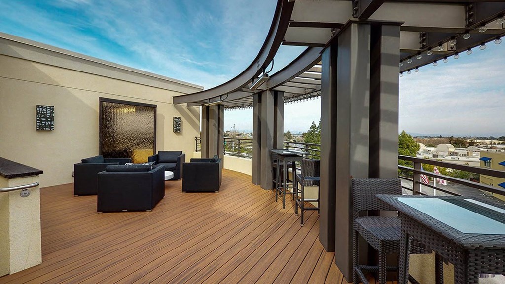 a large deck with furniture and a view of a city