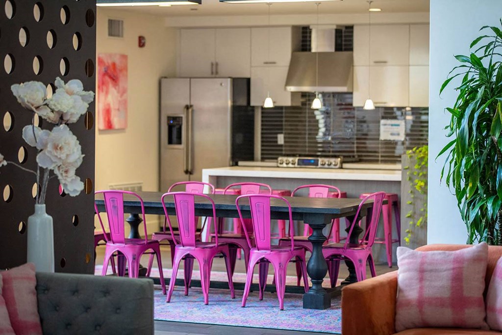 a dining room with pink chairs and a table