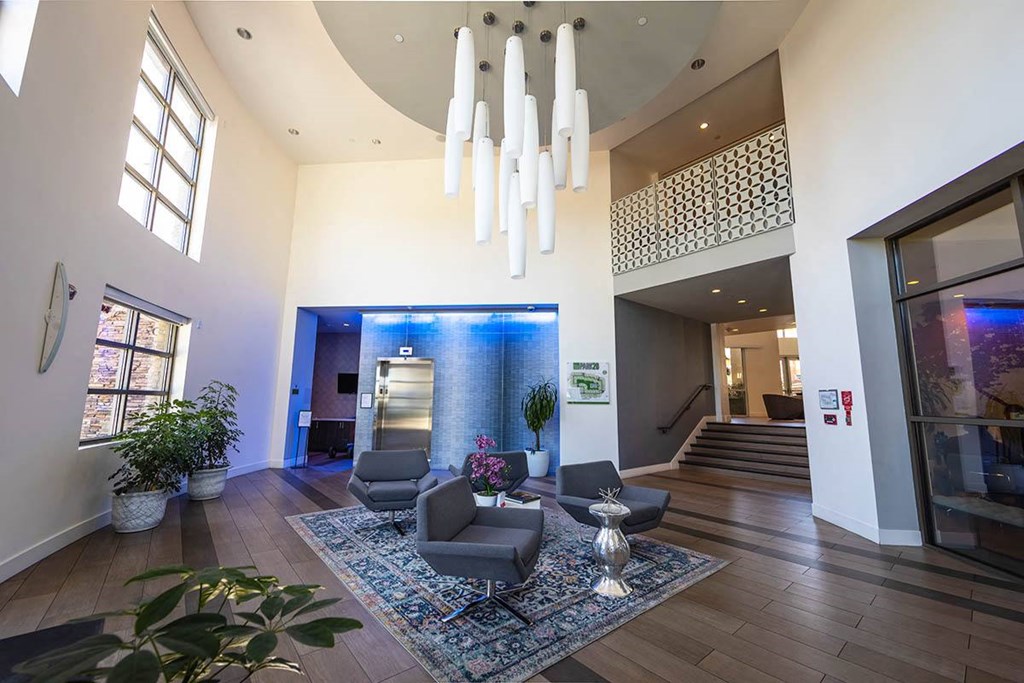 a living room with a water fountain and chairs