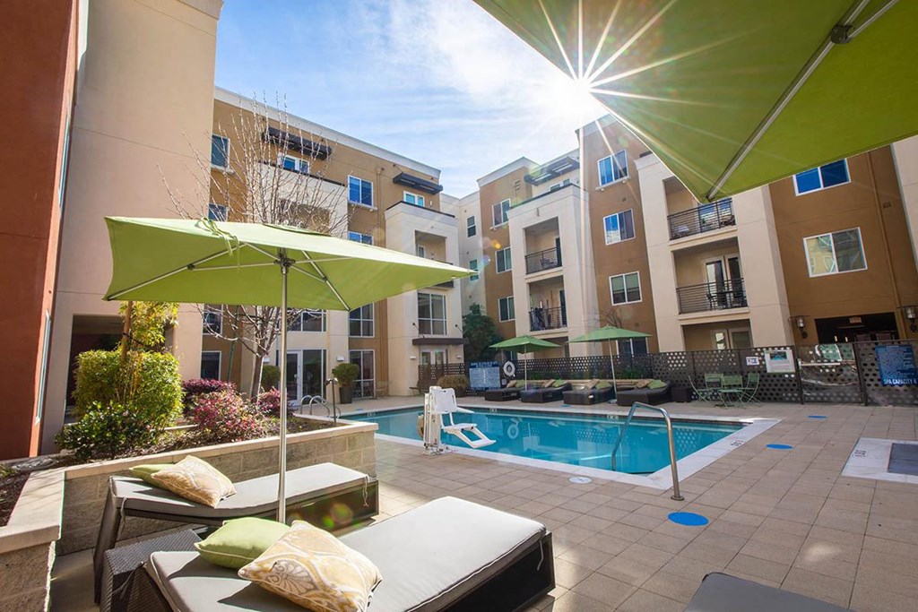 a swimming pool in front of an apartment building