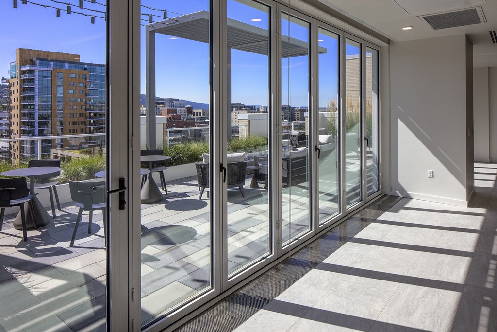 a balcony with a city view and glass doors