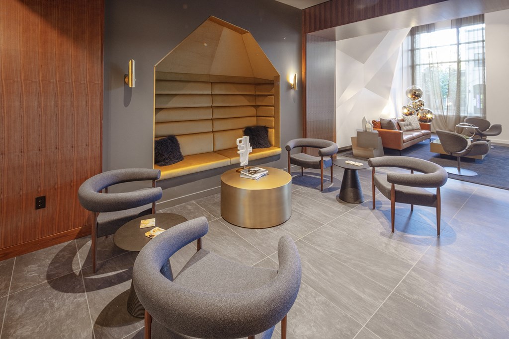 a lounge area with chairs and tables and a fireplace