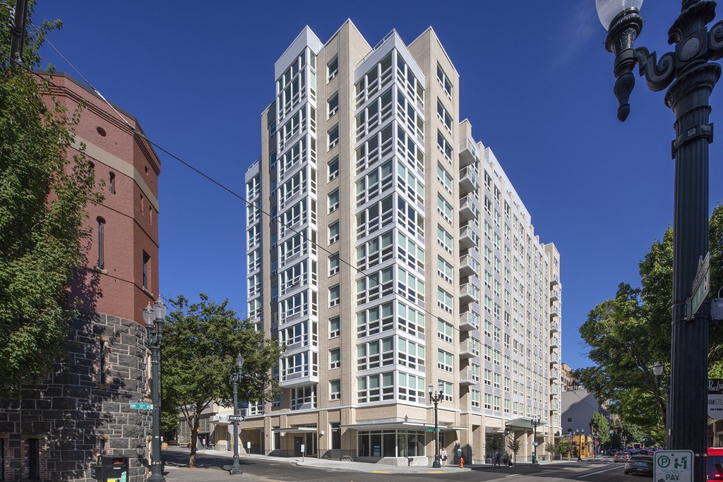 a large white apartment building on a city street