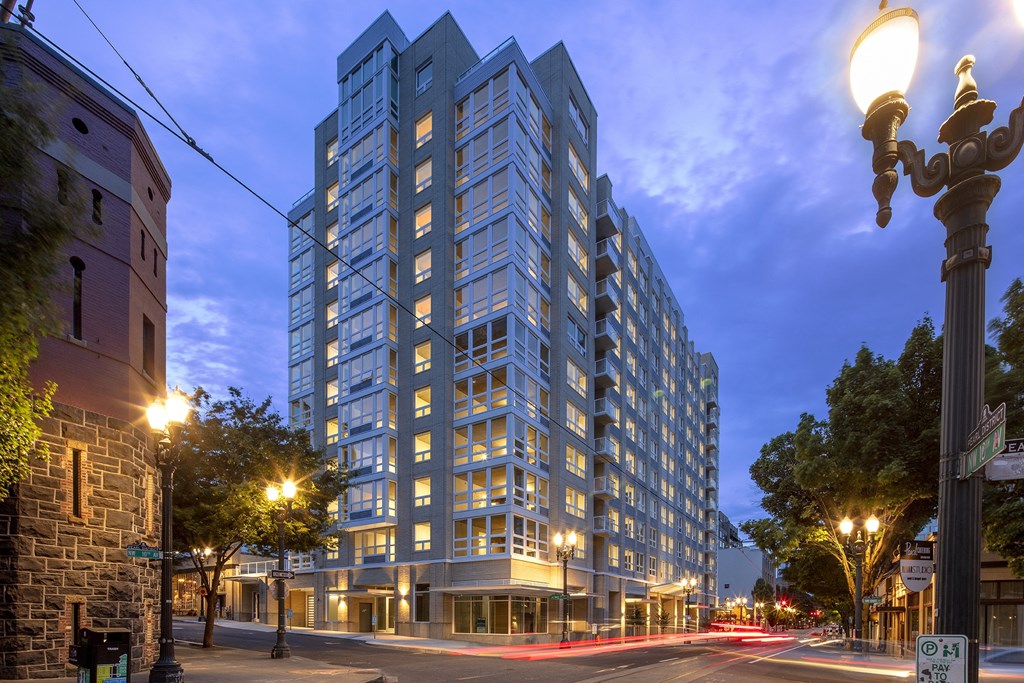 a tall building on a city street at night