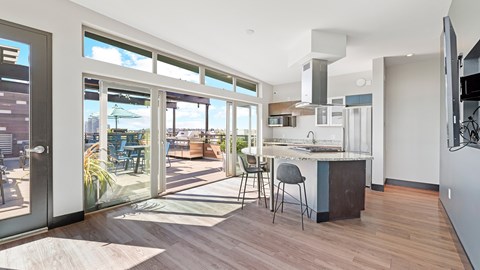 A modern kitchen with a dining table and chairs is shown.