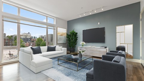 A living room with a large window overlooking a cityscape.