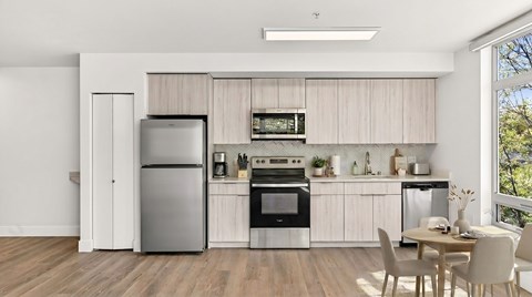 A modern kitchen with a dining table and chairs.