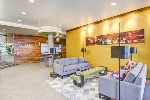 A living room with a grey couch and a coffee table.