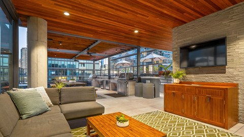 A modern living room with a grey sofa and a wooden coffee table.
