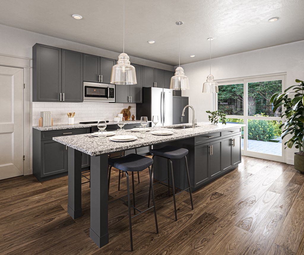 a kitchen with gray cabinets and a marble counter top at Allier Port Wentworth Apartments, Port Wentworth 31407