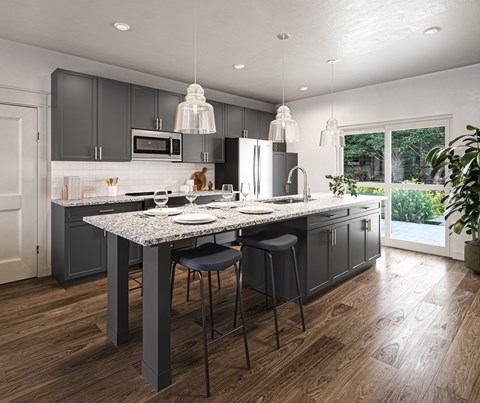 a kitchen with gray cabinets and a marble counter top