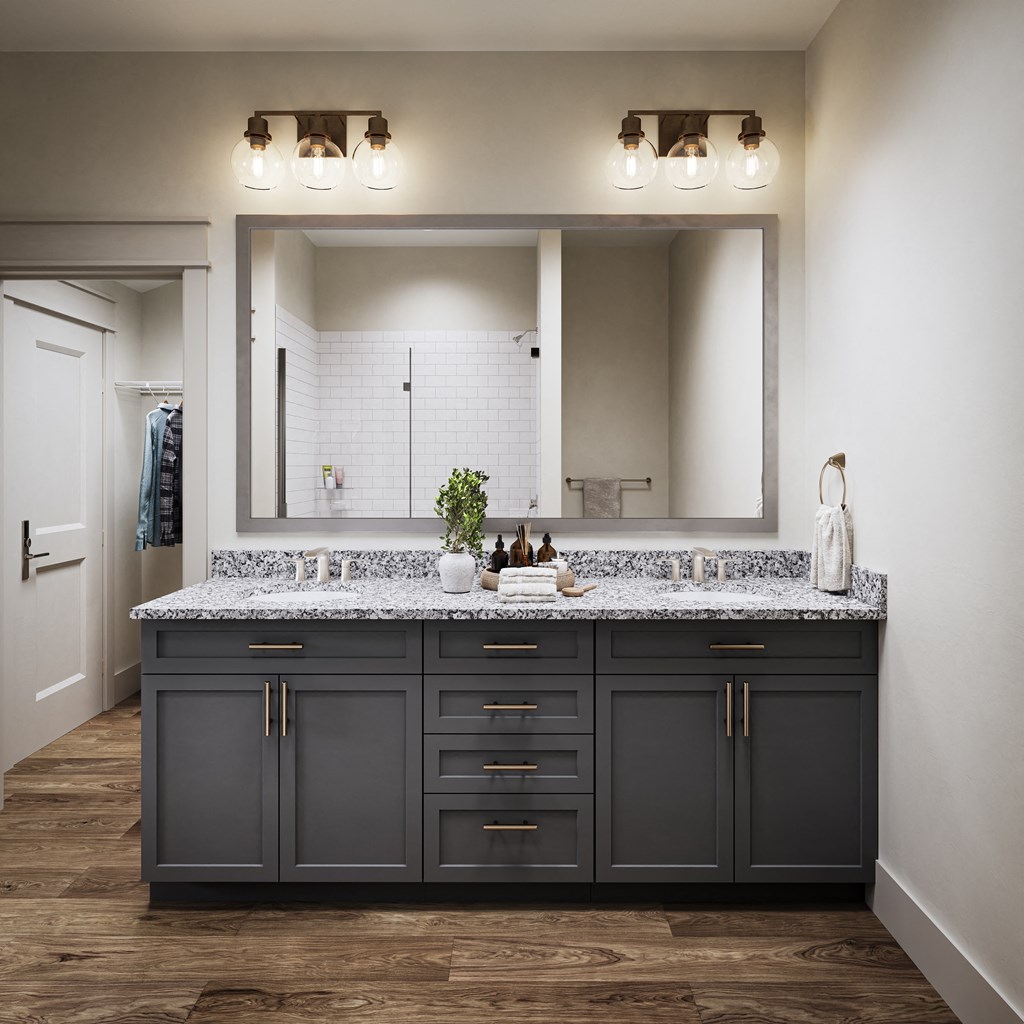 a bathroom with a large mirror and a sink with granite counter tops at Allier Port Wentworth Apartments, Port Wentworth