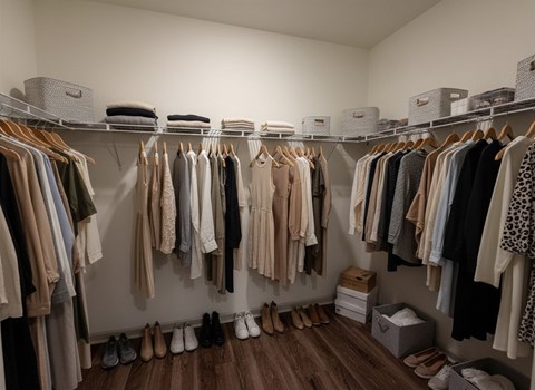 A closet full of clothes and shoes.