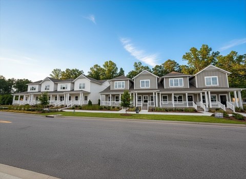A row of houses with a clear blue sky above them.