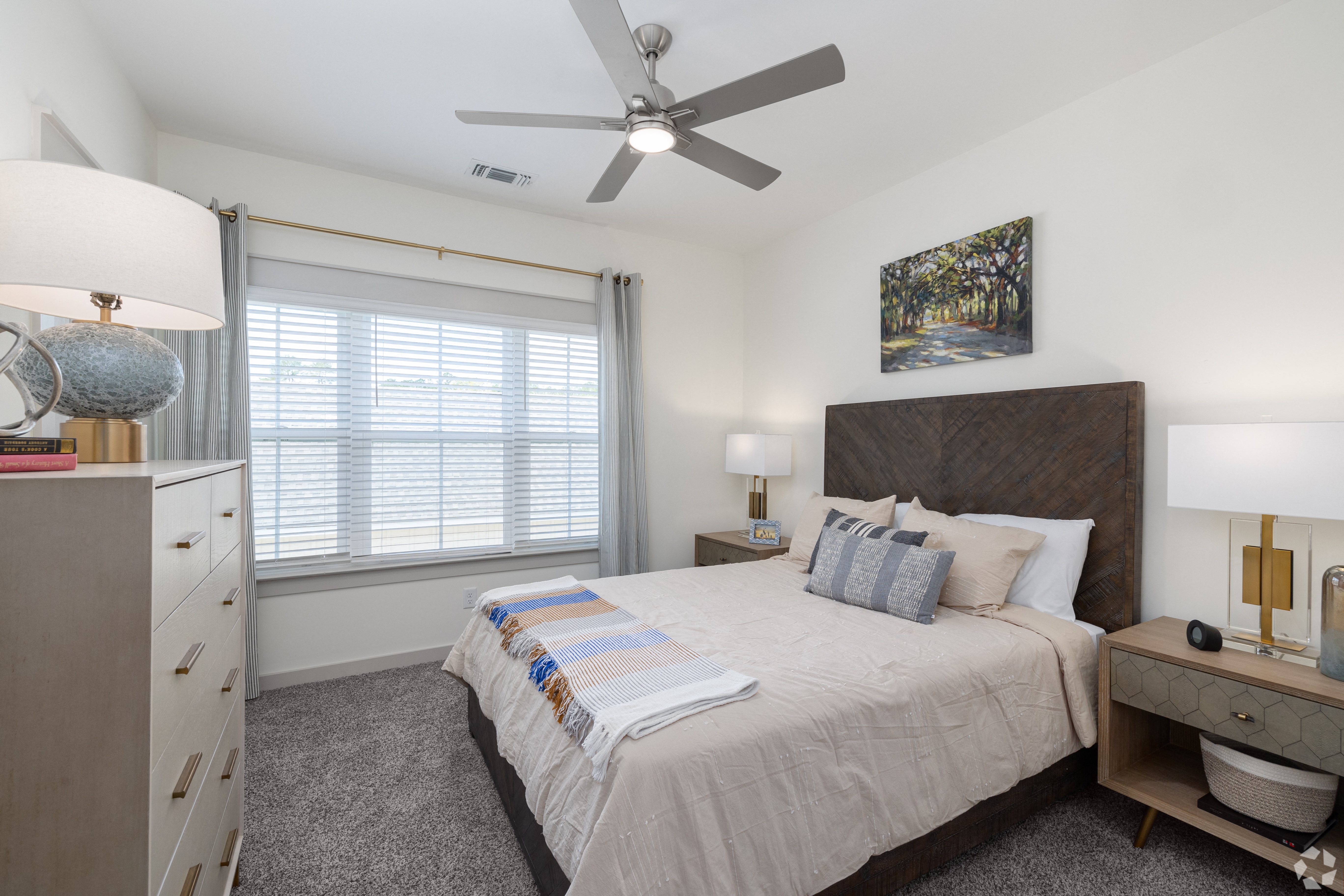a bedroom with a large bed and a ceiling fan