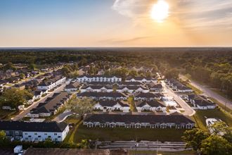 an aerial view of a neighborhood with white houses and black roofs - Photo Gallery