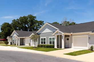 a house with a gray roof and a white garage door - Photo Gallery
