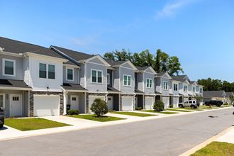 a row of townhomes with a street in front of them - Photo Gallery