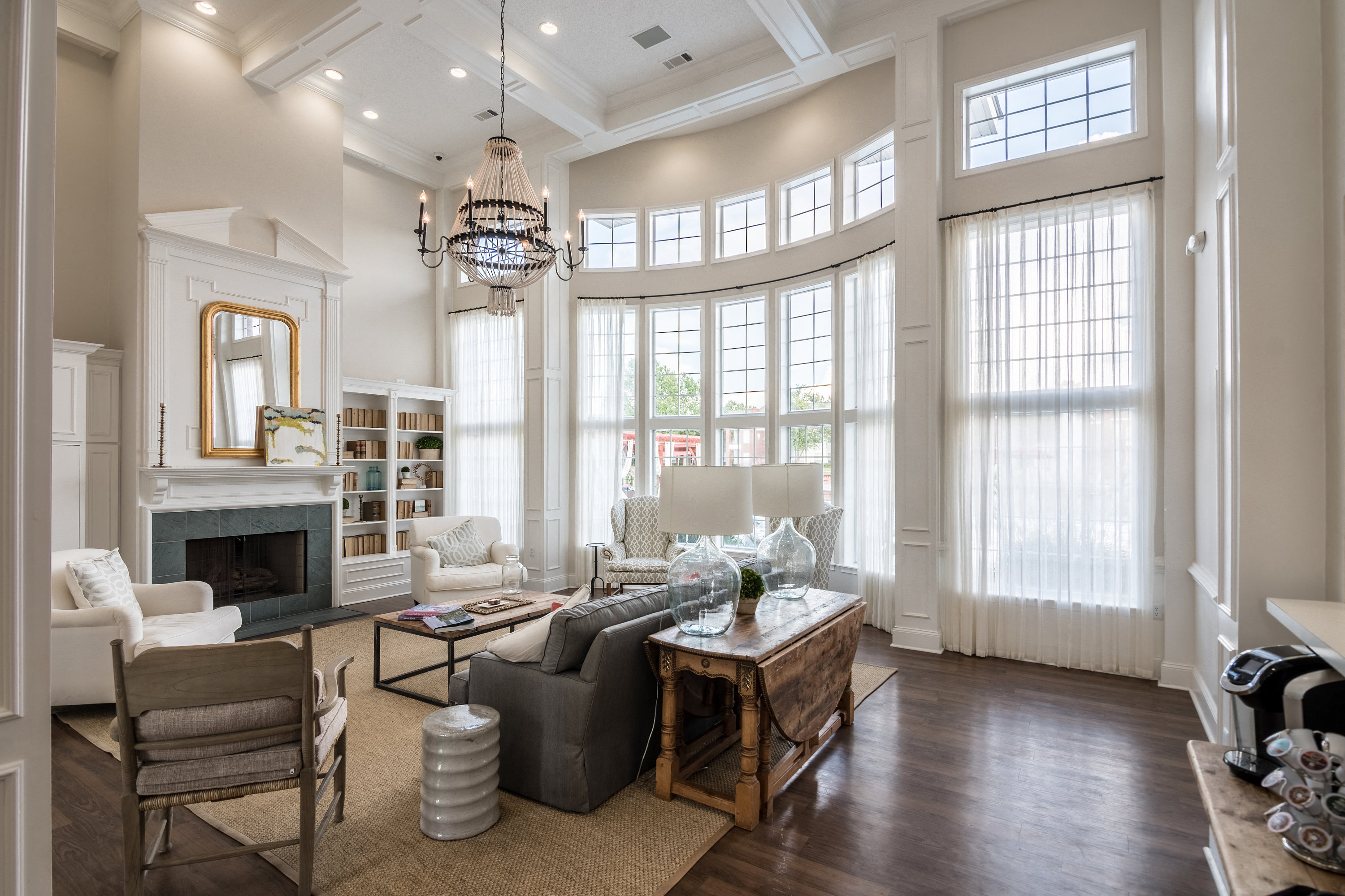 a large living room with large windows and a fireplace