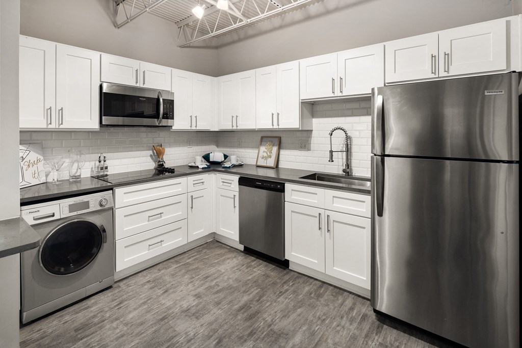 a kitchen with white cabinets and stainless steel appliances at Elevate 758, Mobile, 36602