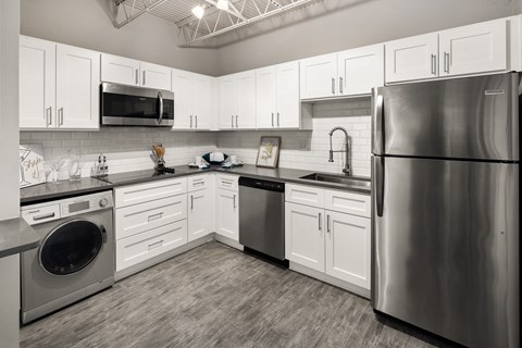 a kitchen with stainless steel appliances and white cabinets