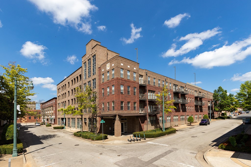 a large brick building on the corner of a city street
