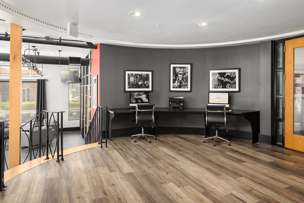 a conference room with two desks and chairs and a glass door