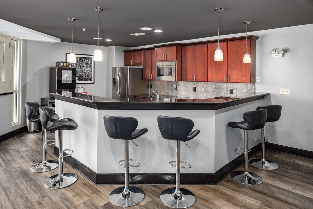 a kitchen with a counter top and chairs